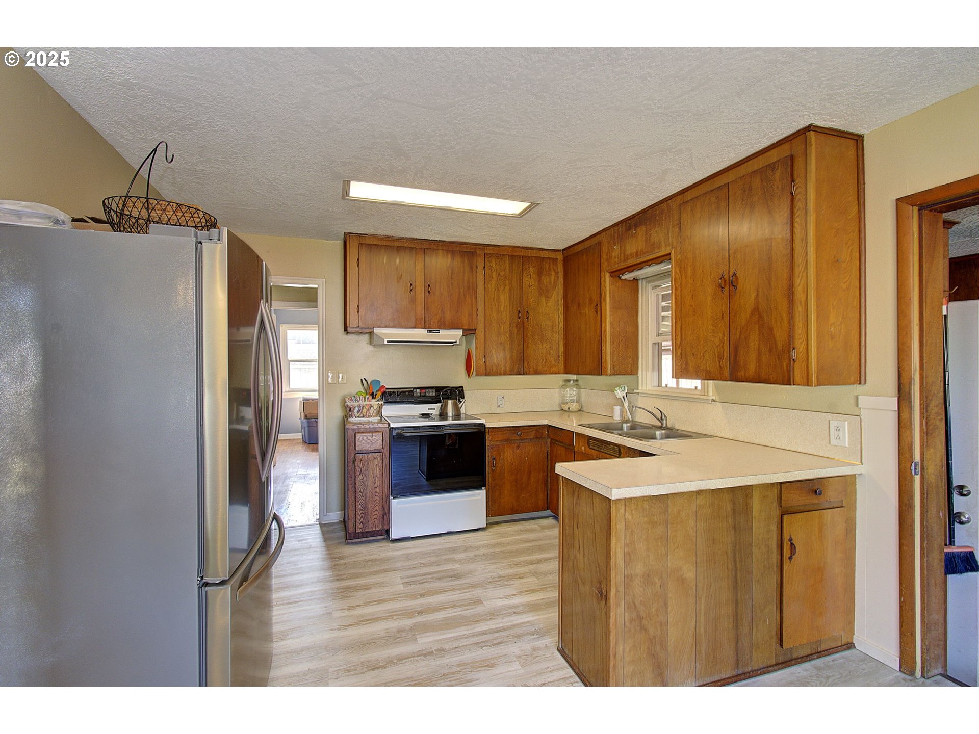 2917 Colorado Street Longview, WA 98632 - Photo 7 of 11 a kitchen with stainless steel appliances granite countertop a refrigerator a sink a stove and island