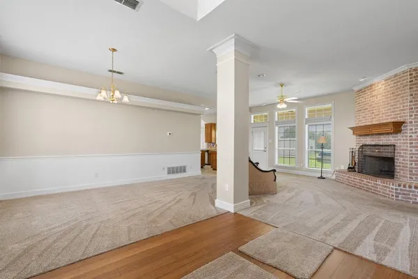 an empty room with fireplace and windows