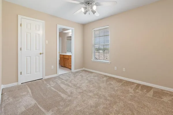 an empty room with windows and cabinet