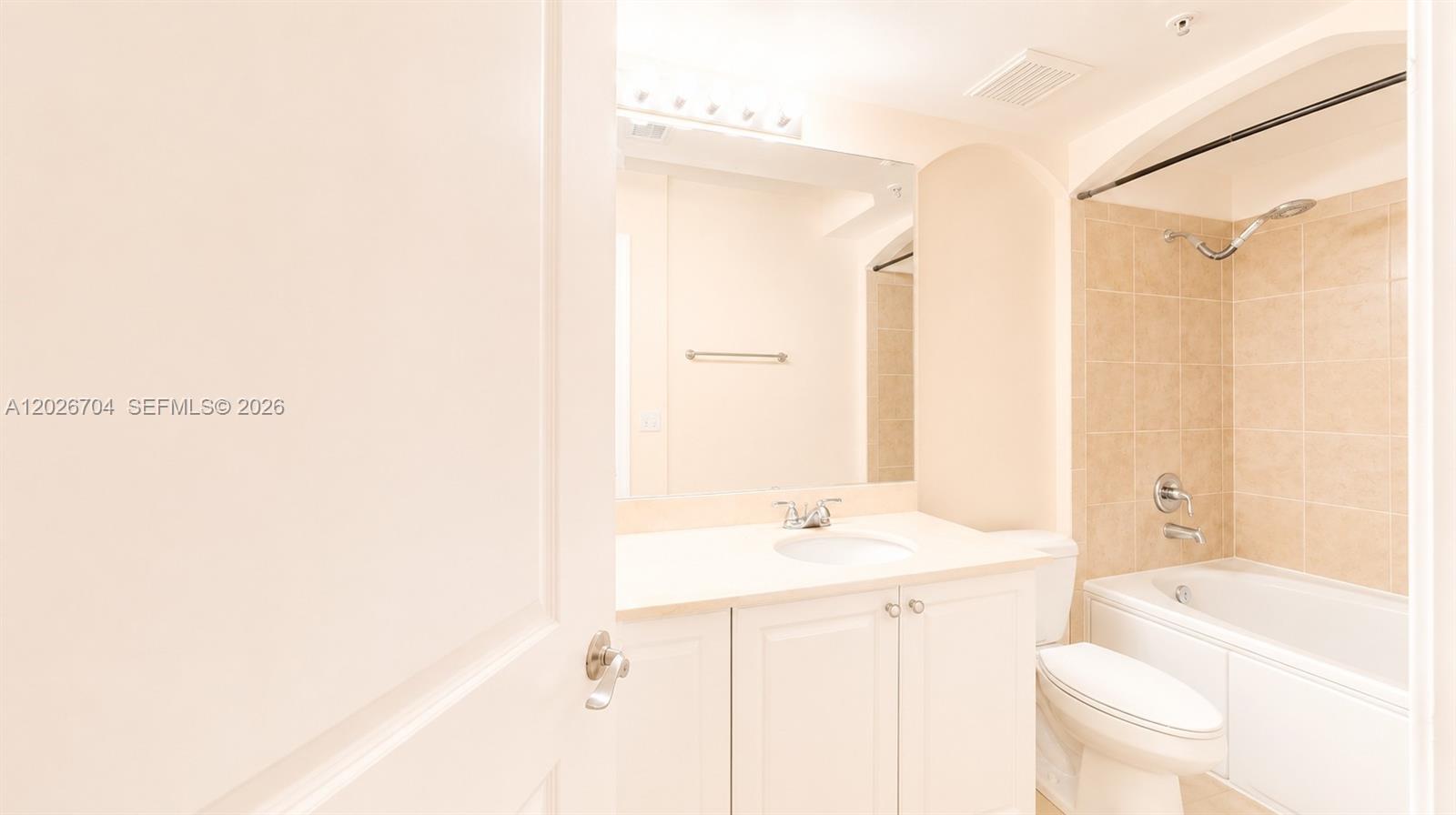 4106 Renaissance Way, Unit 106 Boynton Beach, FL 33426 - Photo 11 of 14 a bathroom with a sink a toilet and shower