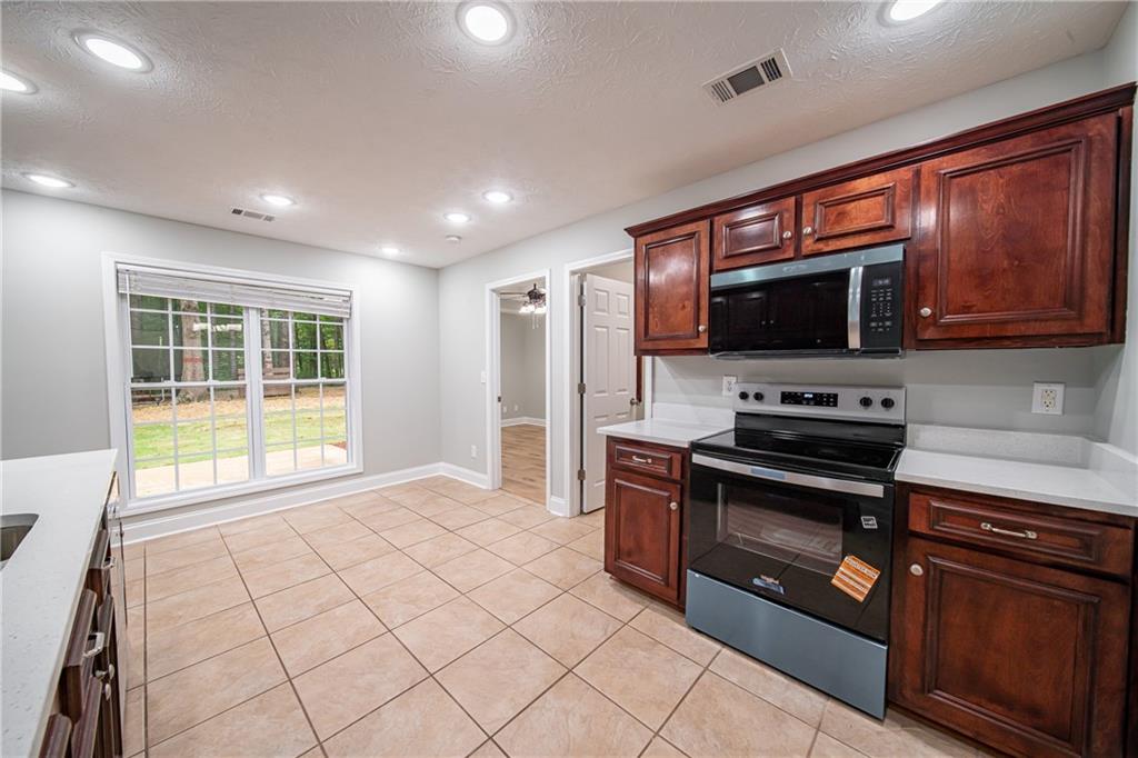 1927 Lee Road Salem, AL 36874 - Photo 23 of 45 Kitchen featuring appliances with stainless steel finishes, light tile patterned flooring, recessed lighting, a textured ceiling, and a ceiling fan