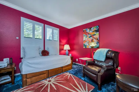 a bedroom with furniture and a window