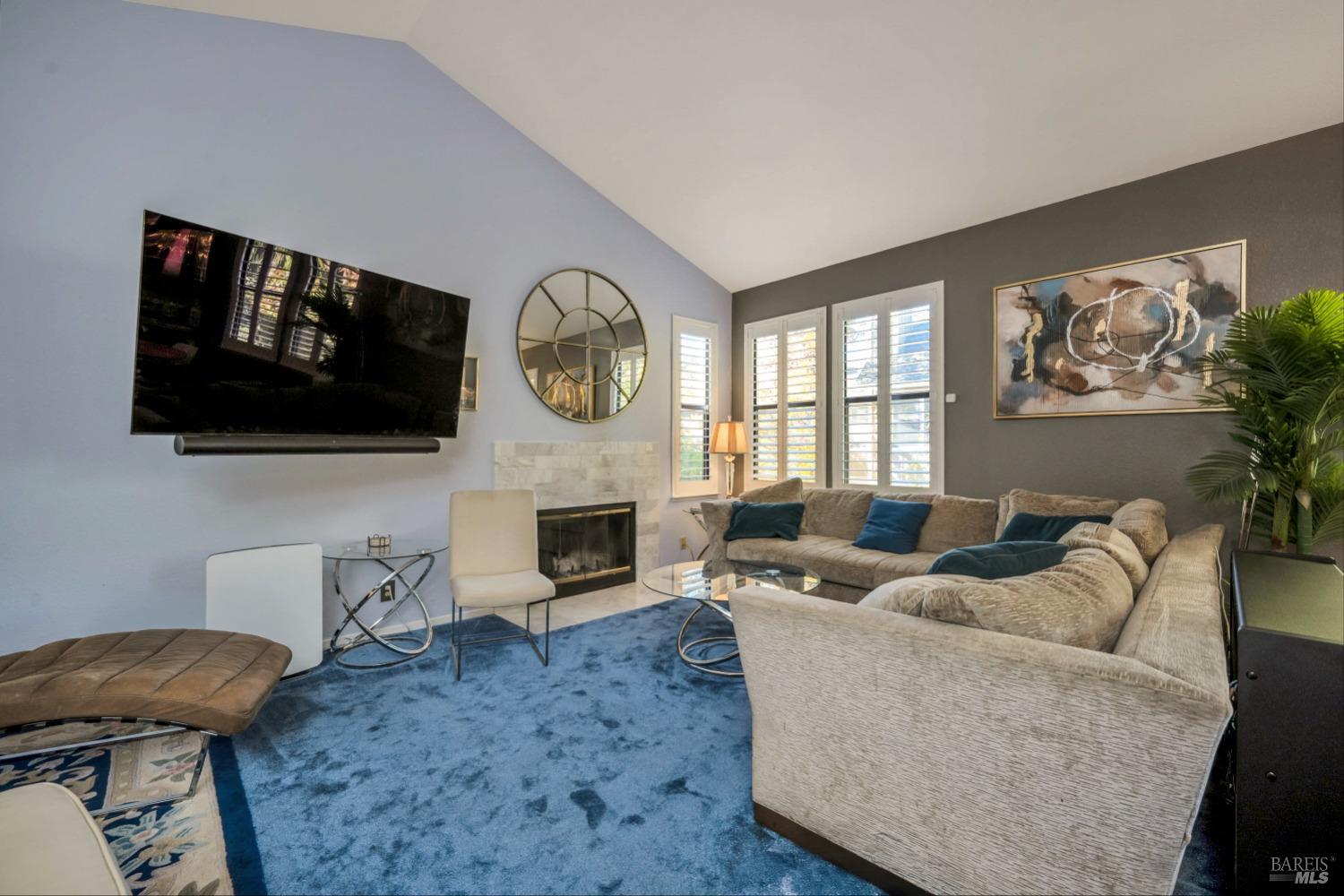 667 Cherry Avenue, Unit 34 Sonoma, CA 95476 - Photo 3 of 20 a living room with furniture a flat screen tv and a fireplace