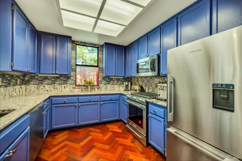 a kitchen with stainless steel appliances granite countertop wooden cabinets a stove a sink and dishwasher
