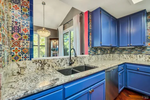 a kitchen with granite countertop a sink and a wooden cabinets