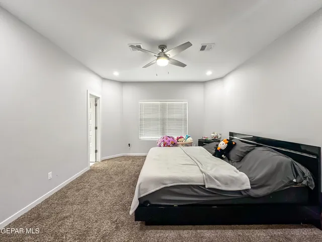 a bathroom with a granite countertop sink toilet mirror and shower
