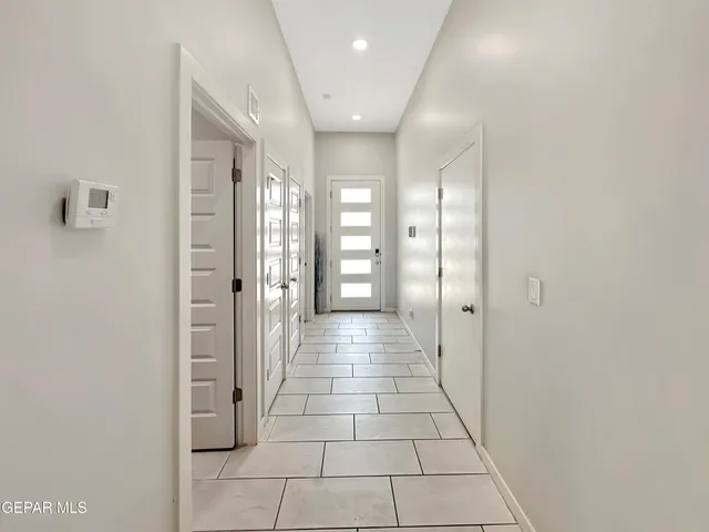 a kitchen with stainless steel appliances granite countertop a sink a stove and a wooden cabinets