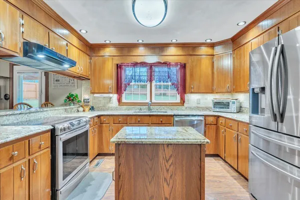 a kitchen with stainless steel appliances granite countertop a stove and a sink