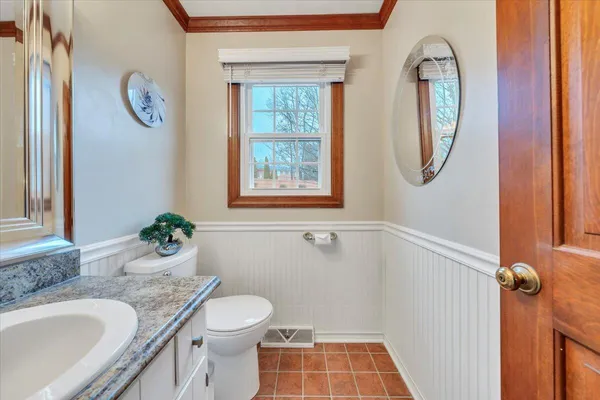 a spacious bathroom with a granite countertop sink and a mirror