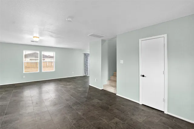 a kitchen with a refrigerator sink and cabinets