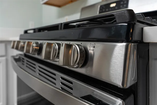 a kitchen with a refrigerator sink and cabinets