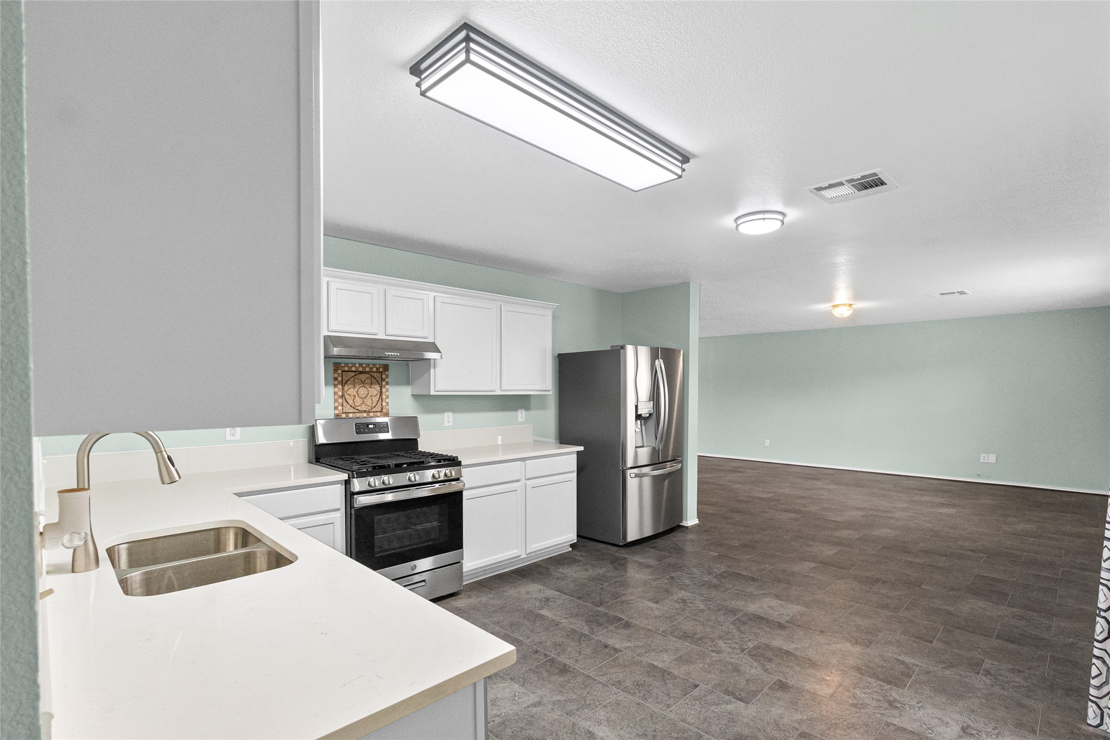 5110 Oak Briar Lane Rosenberg, TX 77469 - Photo 10 of 29 a kitchen with a refrigerator sink and cabinets