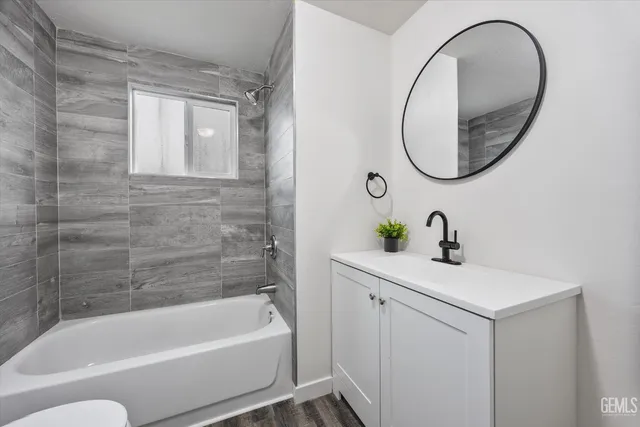 a bathroom with a sink a bathtub and a mirror