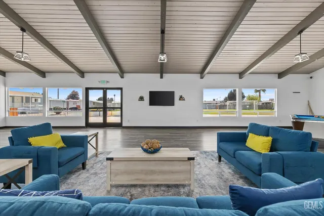 a living room filled with furniture and a wooden floor
