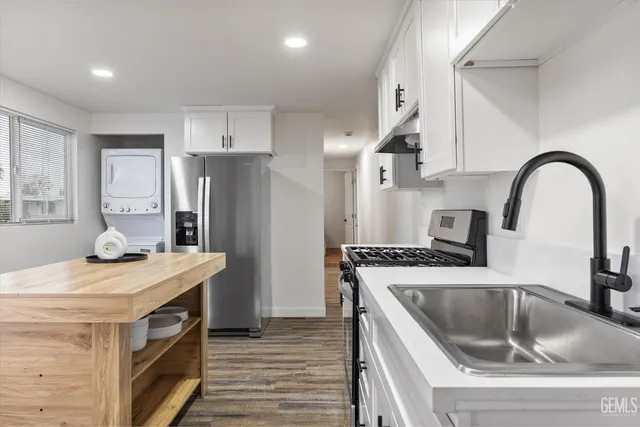 a kitchen with a stove a sink and a refrigerator