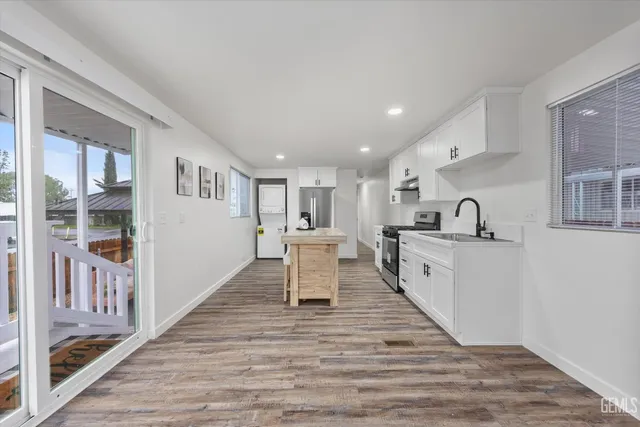 a view of kitchen with wooden floor and electronic appliances