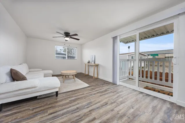 a living room with furniture and a floor to ceiling window