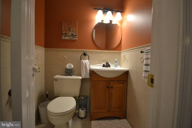 a bathroom with a toilet sink and mirror