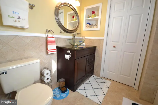a bathroom with a sink mirror vanity and toilet