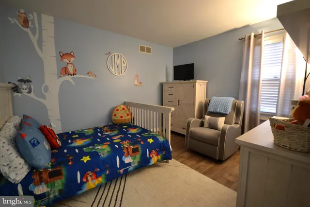 a bedroom with furniture and a window