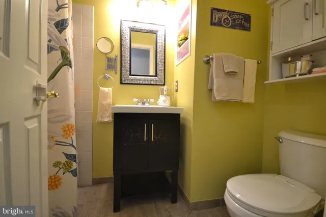 a bathroom with a toilet sink and mirror