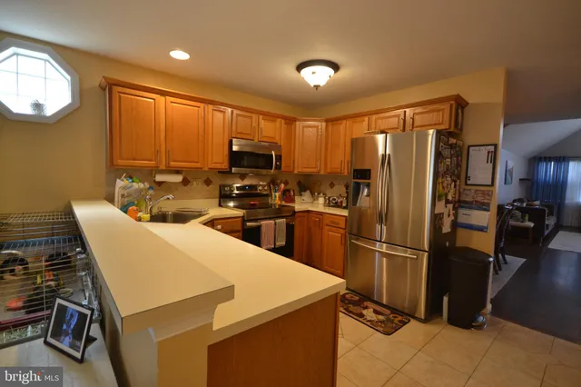 a kitchen with refrigerator cabinets and a stove top oven
