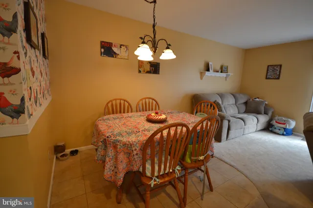a view of a dining room with furniture and a chandelier