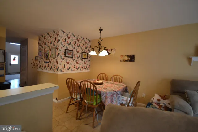 a view of a dining room with furniture and chandelier