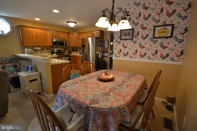 a view of a dining room with furniture and chandelier