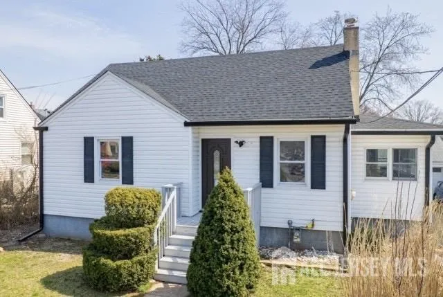 a view of a house with large windows and couches chair