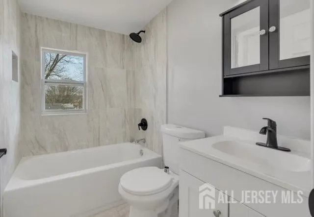 a bathroom with a sink a toilet and a bathtub