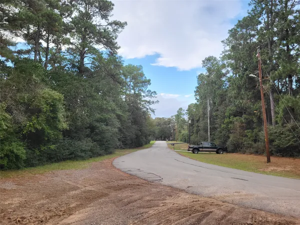 a view of the road with trees in the background