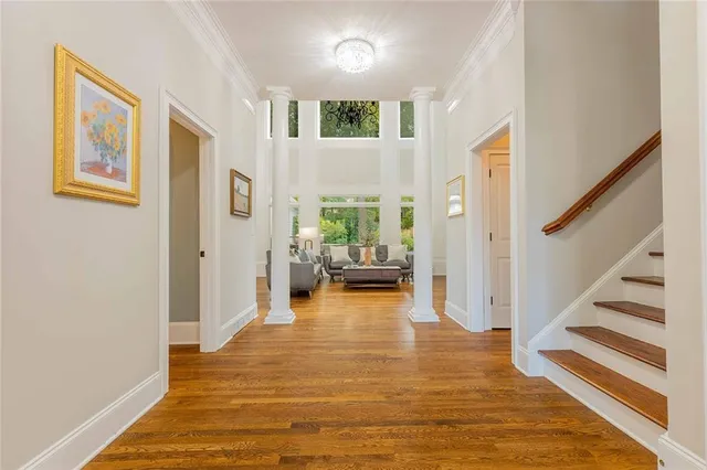 a bedroom with a bed wooden floor and window