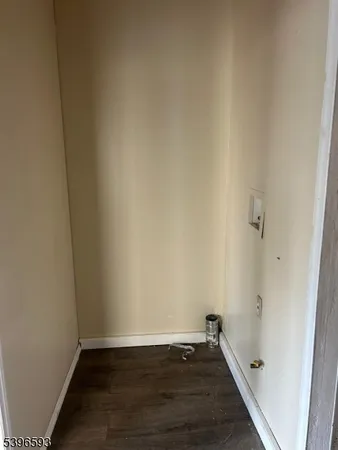 a view of an empty room and wooden floor
