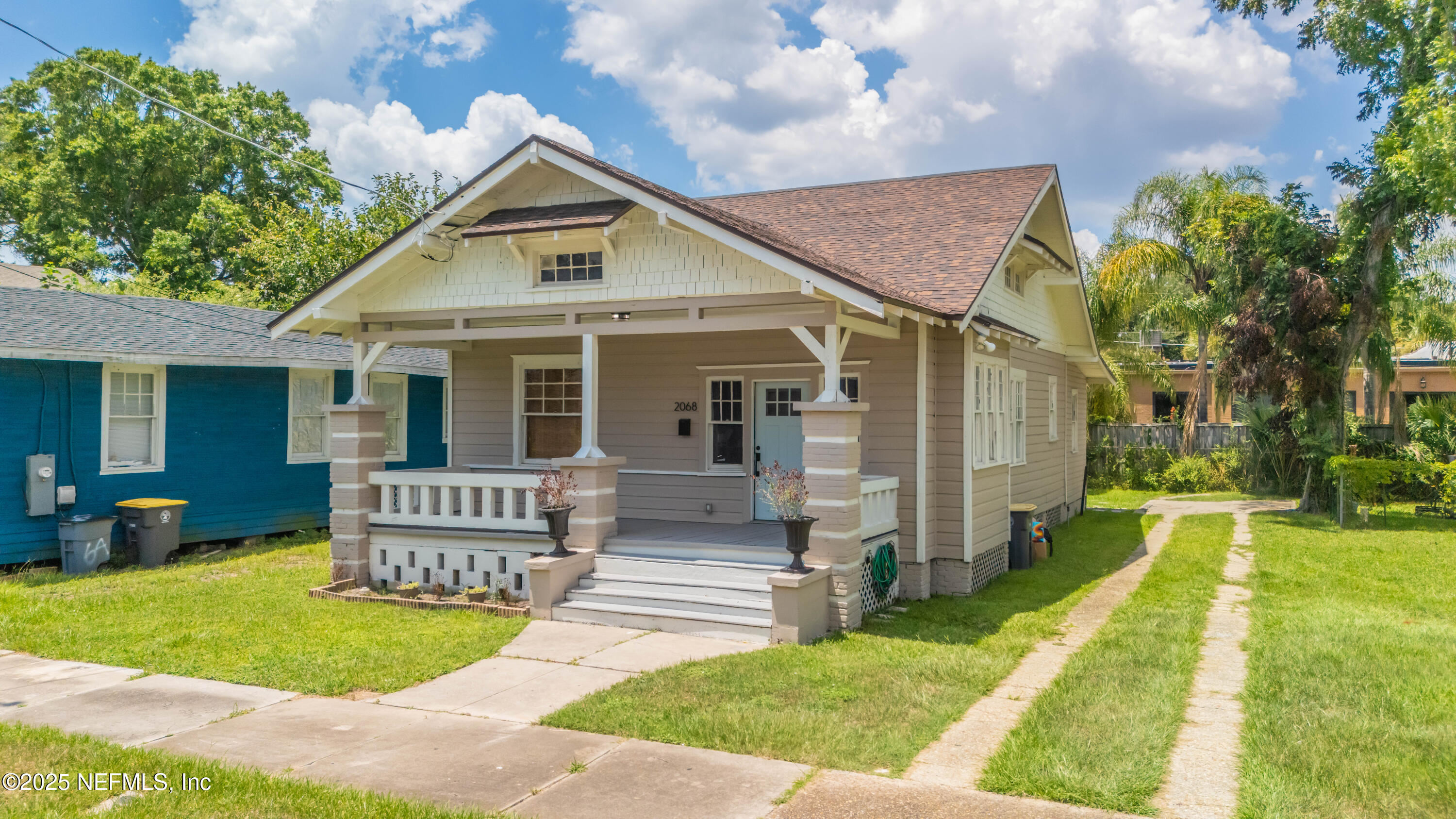 a front view of house with yard and green space
