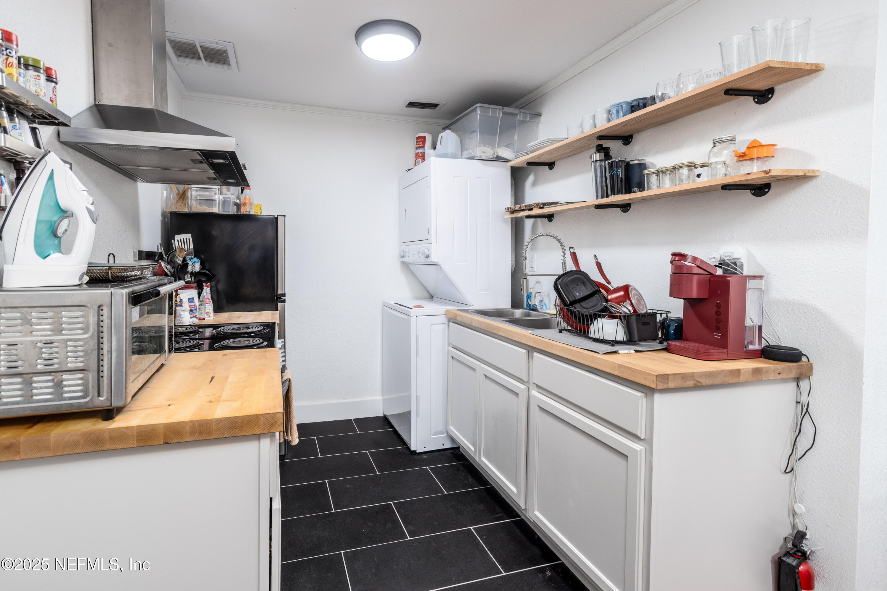 2068 Redwing Street Jacksonville, FL 32206 - Photo 14 of 26 a kitchen with white cabinets and sink