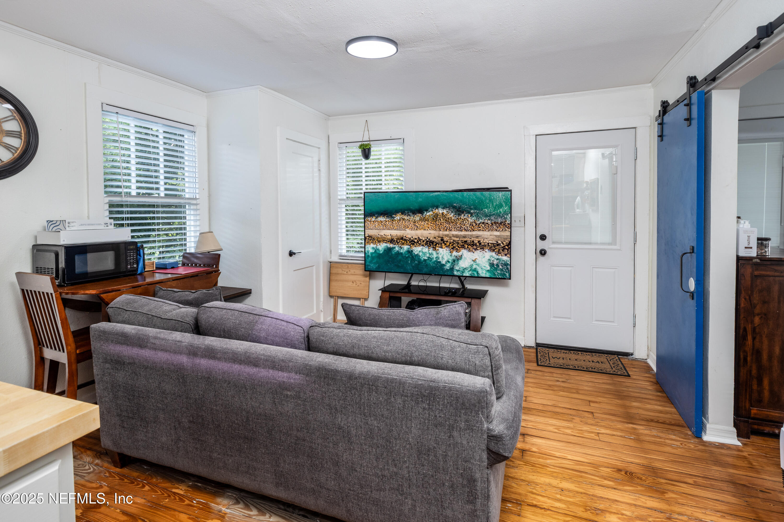 2068 Redwing Street Jacksonville, FL 32206 - Photo 16 of 26 a living room with furniture and a flat screen tv