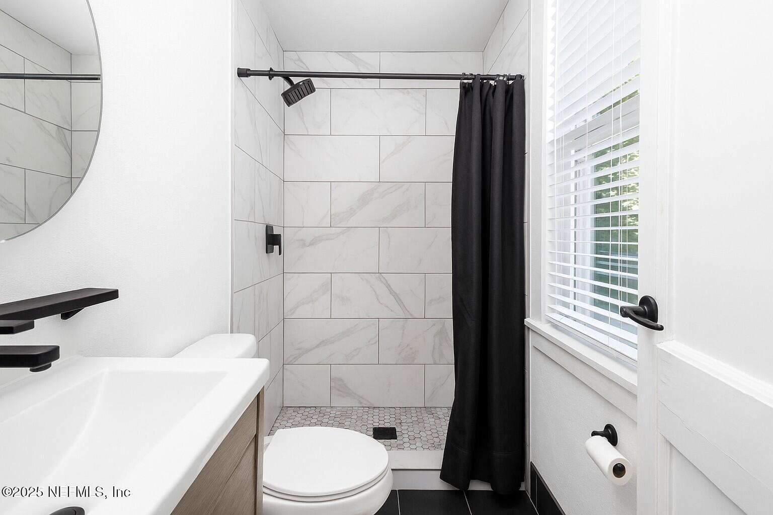 2068 Redwing Street Jacksonville, FL 32206 - Photo 18 of 26 a bathroom with a sink a toilet and shower