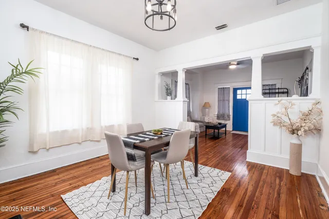a dining room with furniture a rug and wooden floor