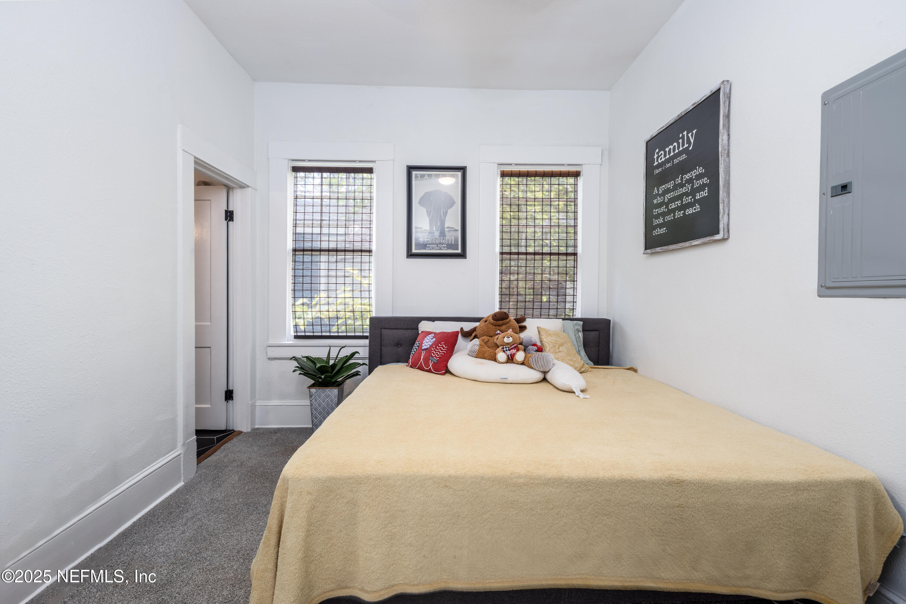 2068 Redwing Street Jacksonville, FL 32206 - Photo 9 of 26 a bedroom with a bed and wooden floor