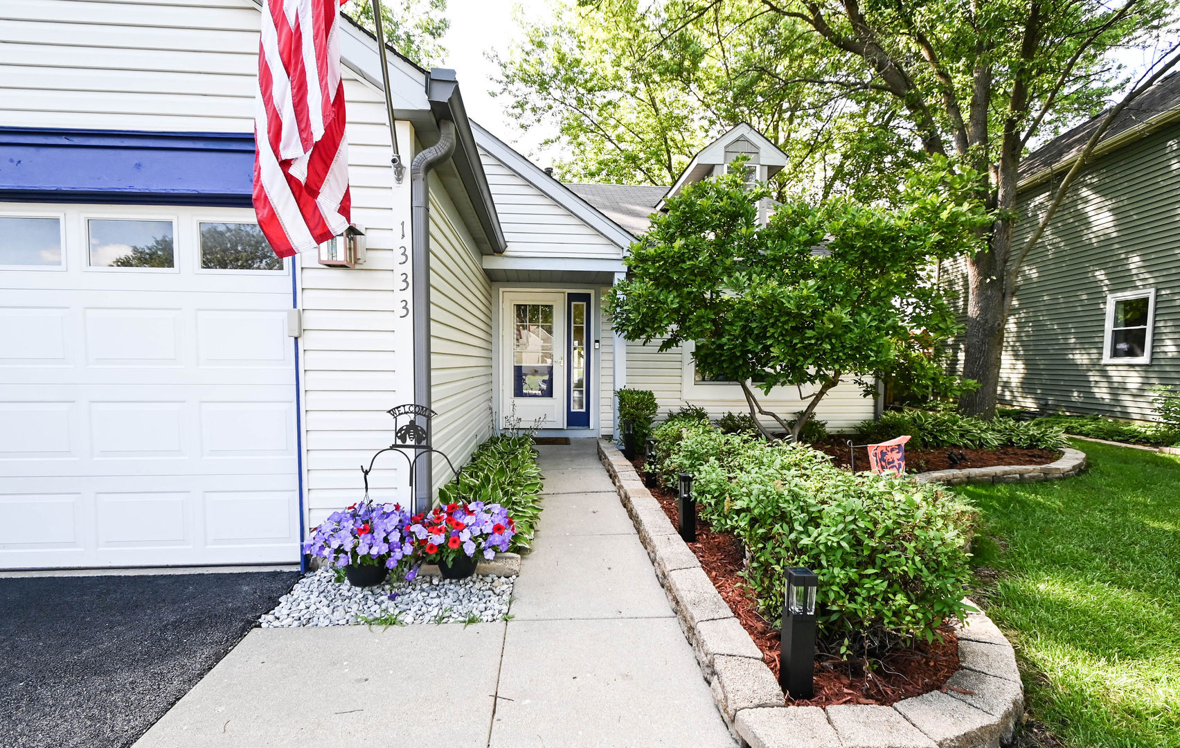 1333 Regency Lane Round Lake, IL 60073 - Photo 2 of 31 a view of a house with potted plants
