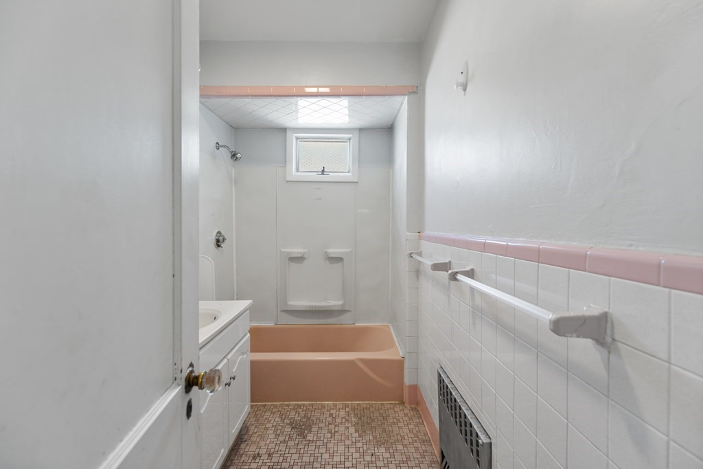 198 Harris Street, Unit 1 Revere, MA 02151 - Photo 5 of 9 a bathroom with a tub a sink and a shower