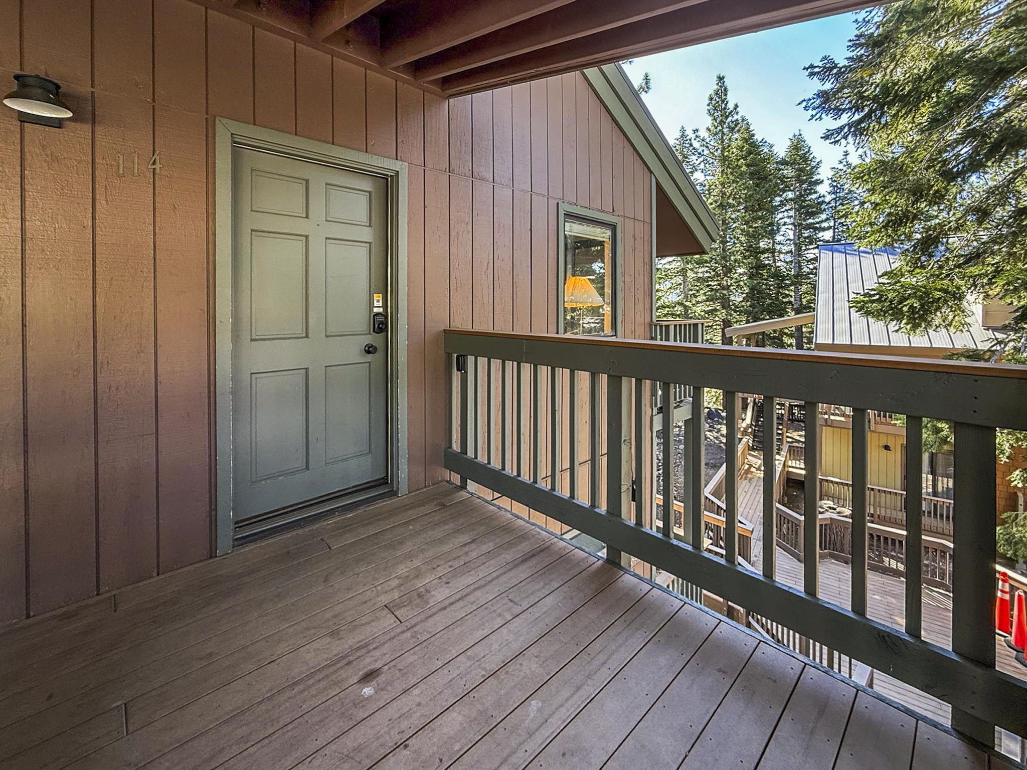 153 Lake Mary Road, Unit 114 Mammoth Lakes, CA 93546 - Photo 17 of 22 Wooden deck balcony with a paneled door entry