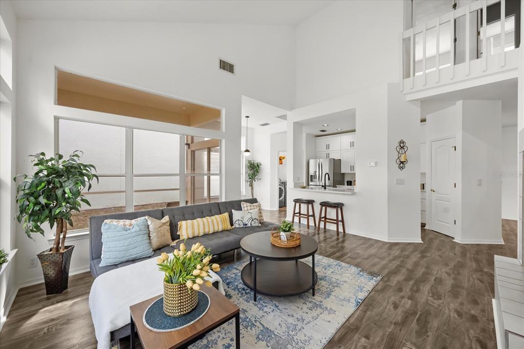 220 Wimbledon Circle Lake Mary, FL 32746 - Photo 11 of 38 a view of a dining room with furniture a potted plant and wooden floor