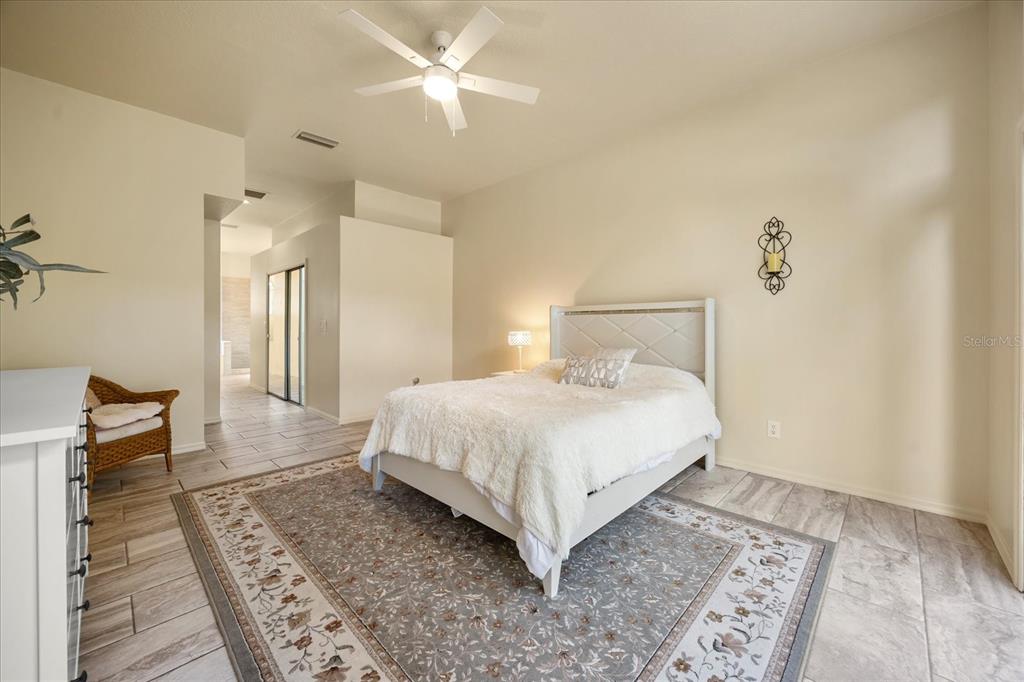 220 Wimbledon Circle Lake Mary, FL 32746 - Photo 17 of 38 a bedroom with a bed and a chandelier