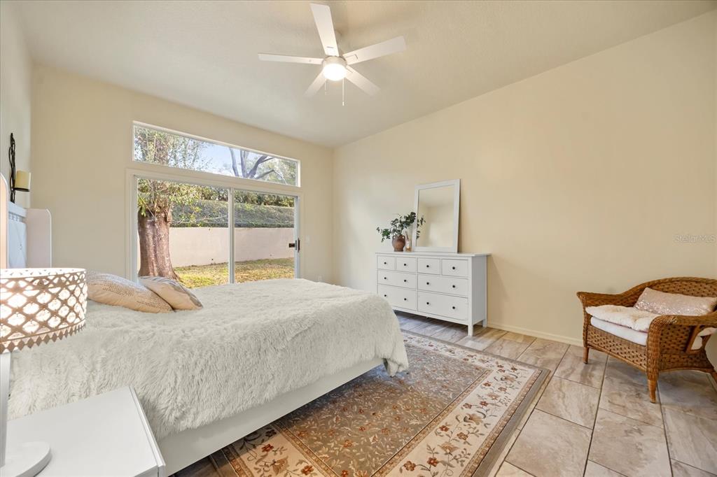 220 Wimbledon Circle Lake Mary, FL 32746 - Photo 18 of 38 a bedroom with a bed and a chandelier