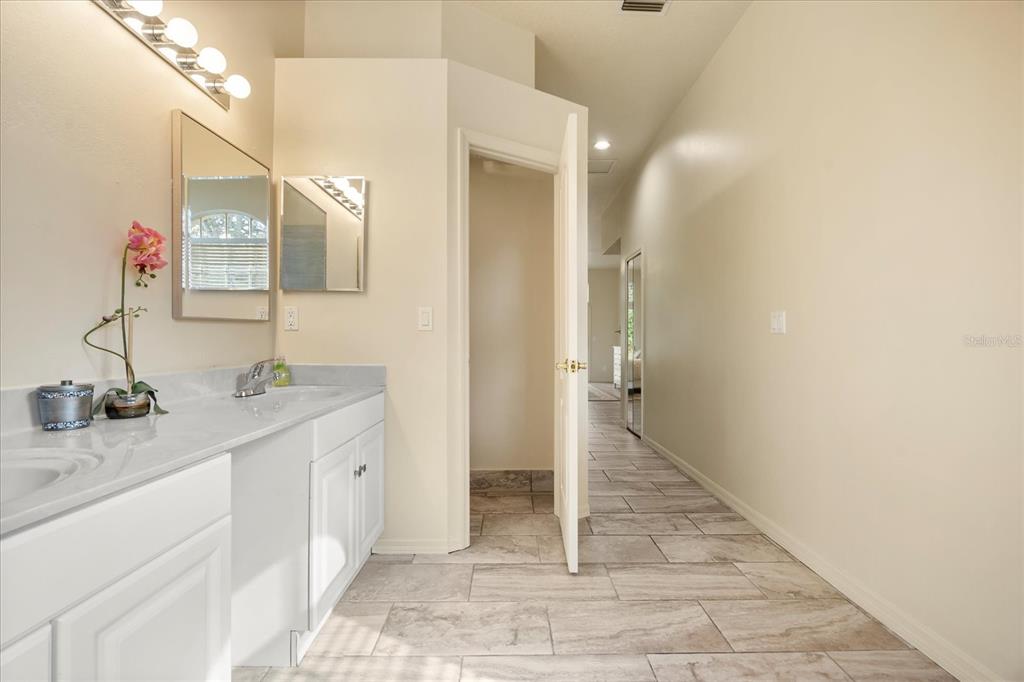 220 Wimbledon Circle Lake Mary, FL 32746 - Photo 23 of 38 a bathroom with a sink and a mirror