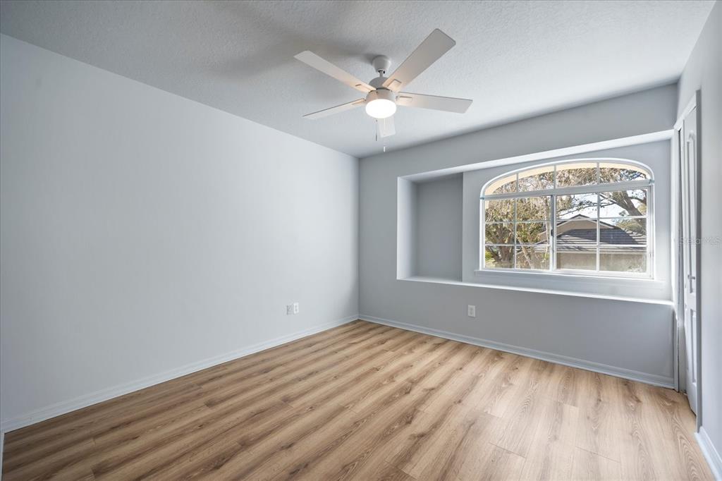 220 Wimbledon Circle Lake Mary, FL 32746 - Photo 25 of 38 a view of an empty room with wooden floor and a window