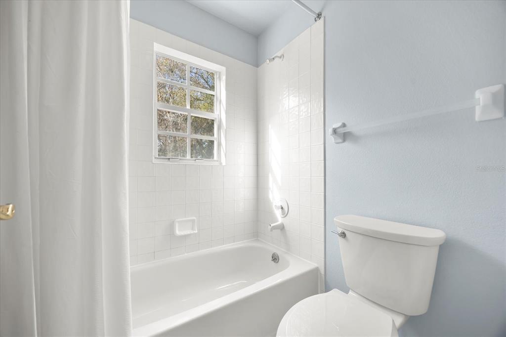 220 Wimbledon Circle Lake Mary, FL 32746 - Photo 27 of 38 a white toilet sitting next to a bath tub