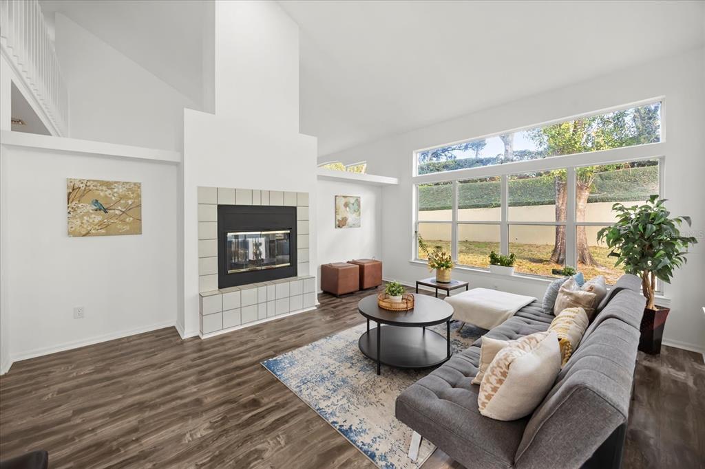 220 Wimbledon Circle Lake Mary, FL 32746 - Photo 10 of 38 a living room with furniture fireplace and a large window
